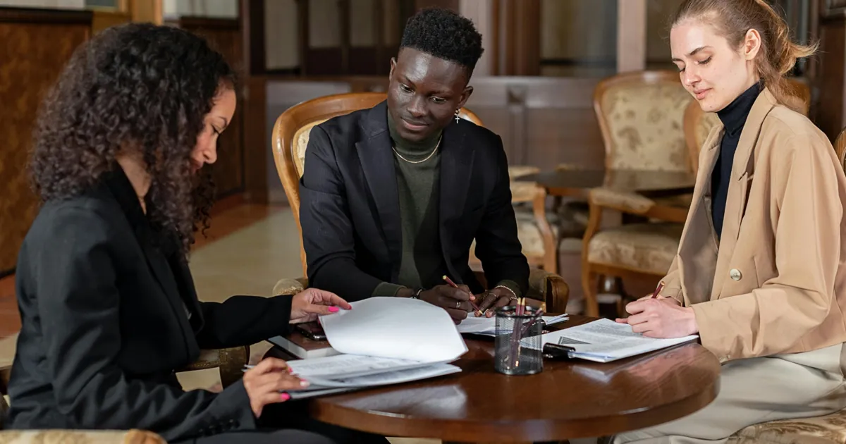 business partners reviewing partnership agreement and tax planning documents related to limited partner self employment tax rules