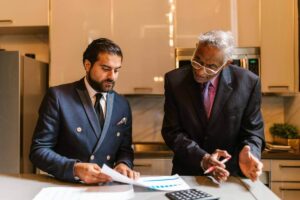 real estate investor reviewing depreciation recapture tax calculations with advisor