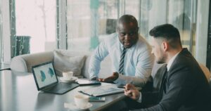 business professionals reviewing financial charts and real estate tax planning strategy