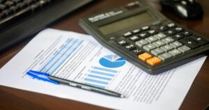 Depreciation recapture tax planning with financial documents and calculator